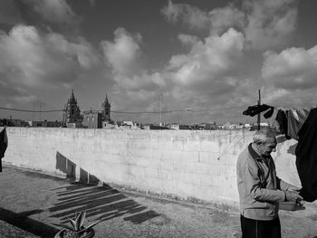 People standing in city against sky