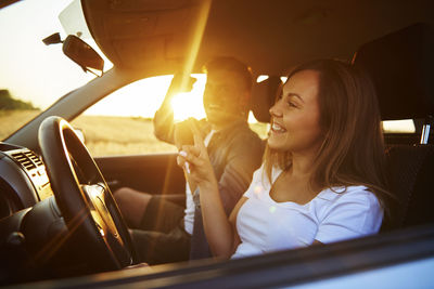 Smiling couple sitting in car