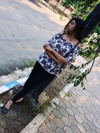 High angle view of woman sitting outdoors