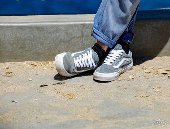 Low section of man wearing canvas shoes