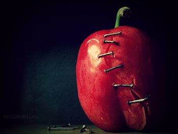 Close-up of red apple against black background