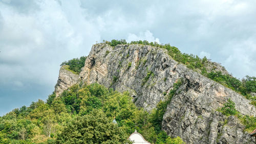 Low angle view of rocks on mountain against sky