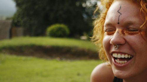 Close-up portrait of smiling young woman