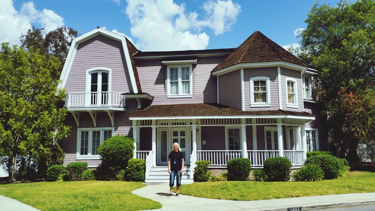 building exterior, architecture, built structure, grass, sky, lawn, tree, facade, window, men, cloud, sunlight, day, green color, cloud - sky, outdoors, building, house