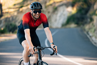 Man riding bicycle on road