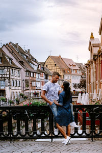 People sitting on chair against buildings