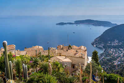 High angle view of townscape by sea against sky