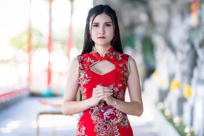 Portrait of beautiful young woman standing outdoors