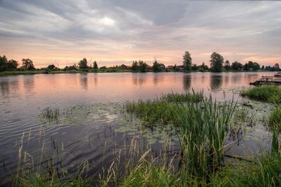 Scenic view of lake against sky during sunset