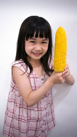 Close-up portrait of a smiling girl over white background