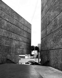 Road by building against sky