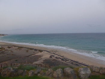 Scenic view of beach against clear sky