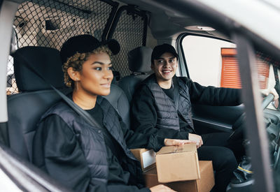 Portrait of young couple sitting in car