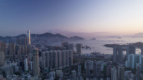 Aerial view of cityscape against sky during sunset