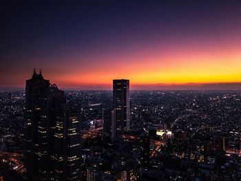 High angle view of city lit up at night