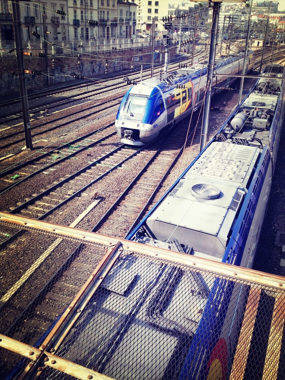 transportation, railroad track, mode of transport, public transportation, rail transportation, high angle view, train - vehicle, railroad station platform, railroad station, land vehicle, travel, car, train, day, passenger train, no people, public transport, city, outdoors, journey