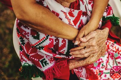 Midsection of couple holding hands