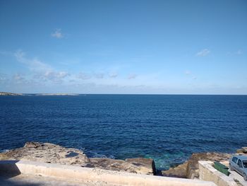 Scenic view of sea against blue sky