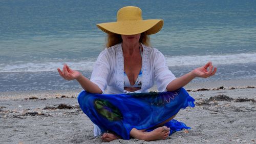 Woman meditating at beach