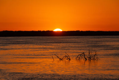 Scenic view of lake against romantic sky at sunrise