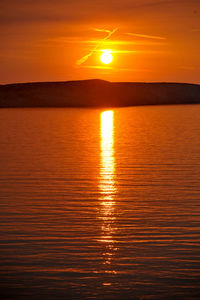 Scenic view of sea against romantic sky at sunset