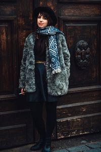 Portrait of smiling young woman standing outdoors