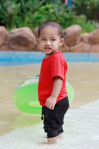 Boy standing in swimming pool