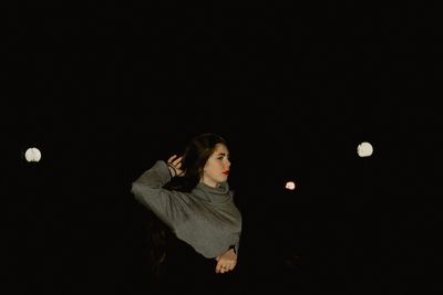Woman embracing friend at night