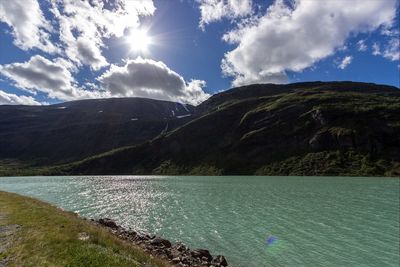 Scenic view of mountain range against cloudy sky