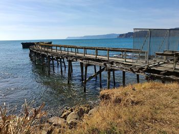 Pier over sea against sky
