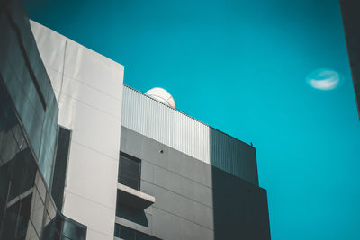 Low angle view of building against clear blue sky