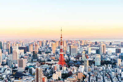 High angle view of city buildings against sky during sunset