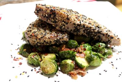 Close-up of tuna fish garnished with sesame seeds in plate