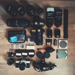 Directly above shot of cameras and lenses on table