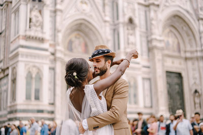 Man and woman standing in front of historical building