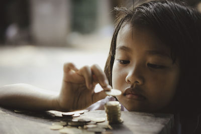 Close-up portrait of boy holding table