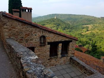 Built structure on mountain against sky