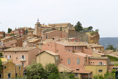 Buildings in city against clear sky