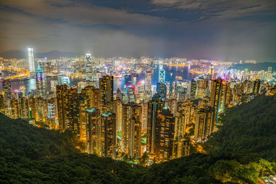 Illuminated cityscape against sky at night