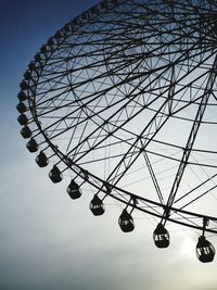 Low angle view of ferris wheel against sky