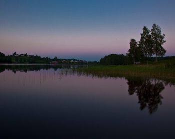 Reflection of trees in calm lake