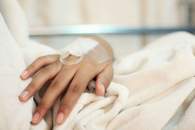 Cropped hand of patient at hospital