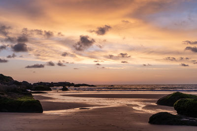 Scenic view of beach against sky during sunset