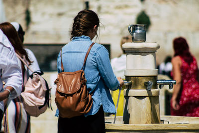 Rear view of people standing outdoors