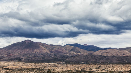 Scenic view of mountains against cloudy sky