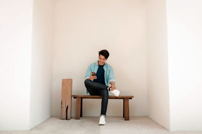 Young man sitting on chair at home