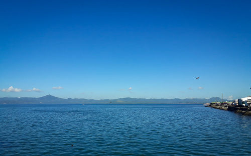 Scenic view of sea against clear blue sky