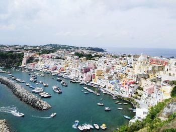 High angle view of townscape and sea against sky