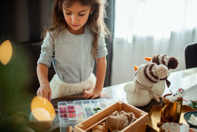 Full length of girl holding toy at home