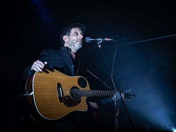 Man playing guitar at music concert